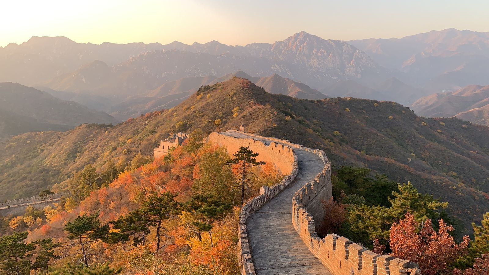 The Great Wall of China winding over autumn hills near Beijing, the usual first stop on a China tour with a Yangtze river cruise
